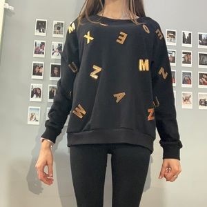 Black sweatshirt with gold letters